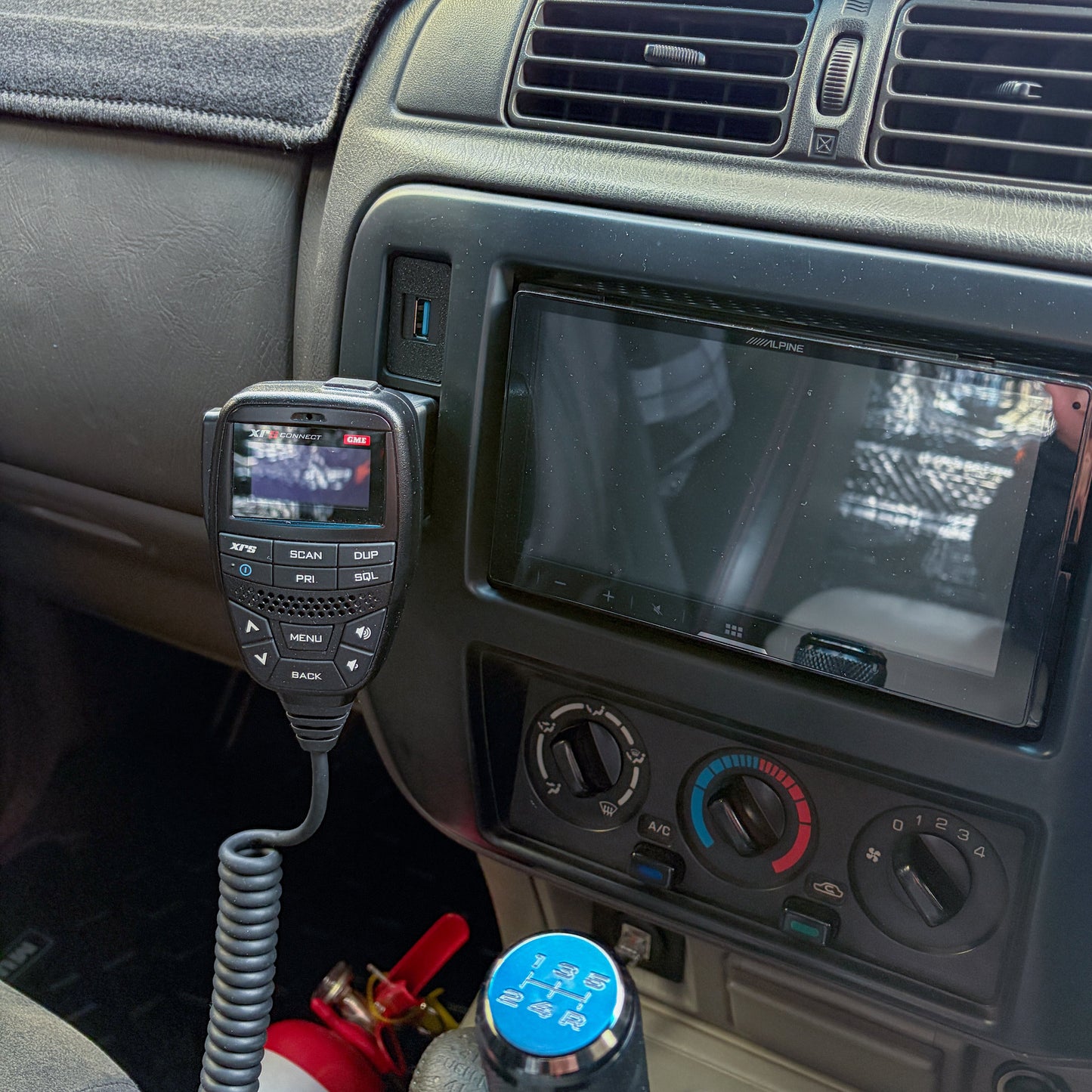 Nissan Patrol GU Series 1-3 UHF mount installed to GU Patrol radio trim installed in car with GME XRS radio mounted