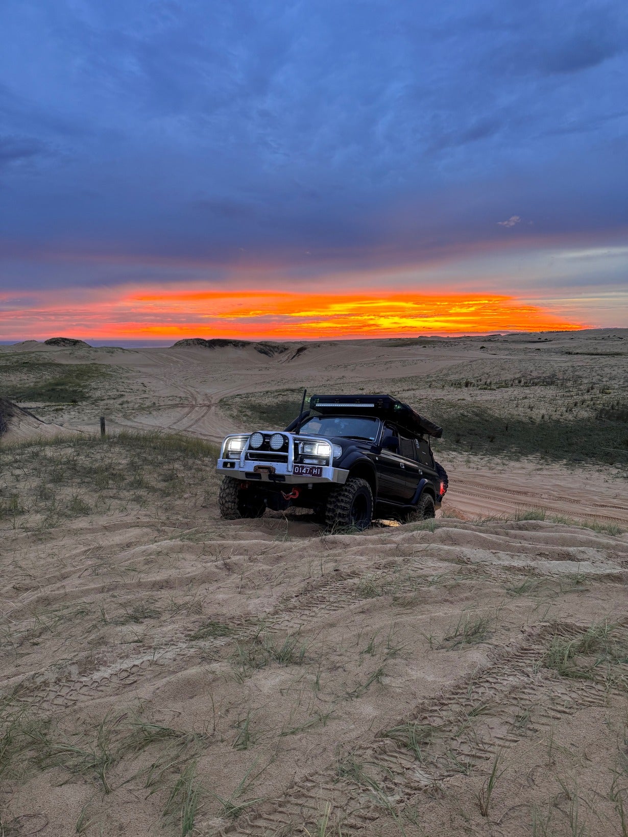 Toyota Landcruiser 80 series front view beach with sunset