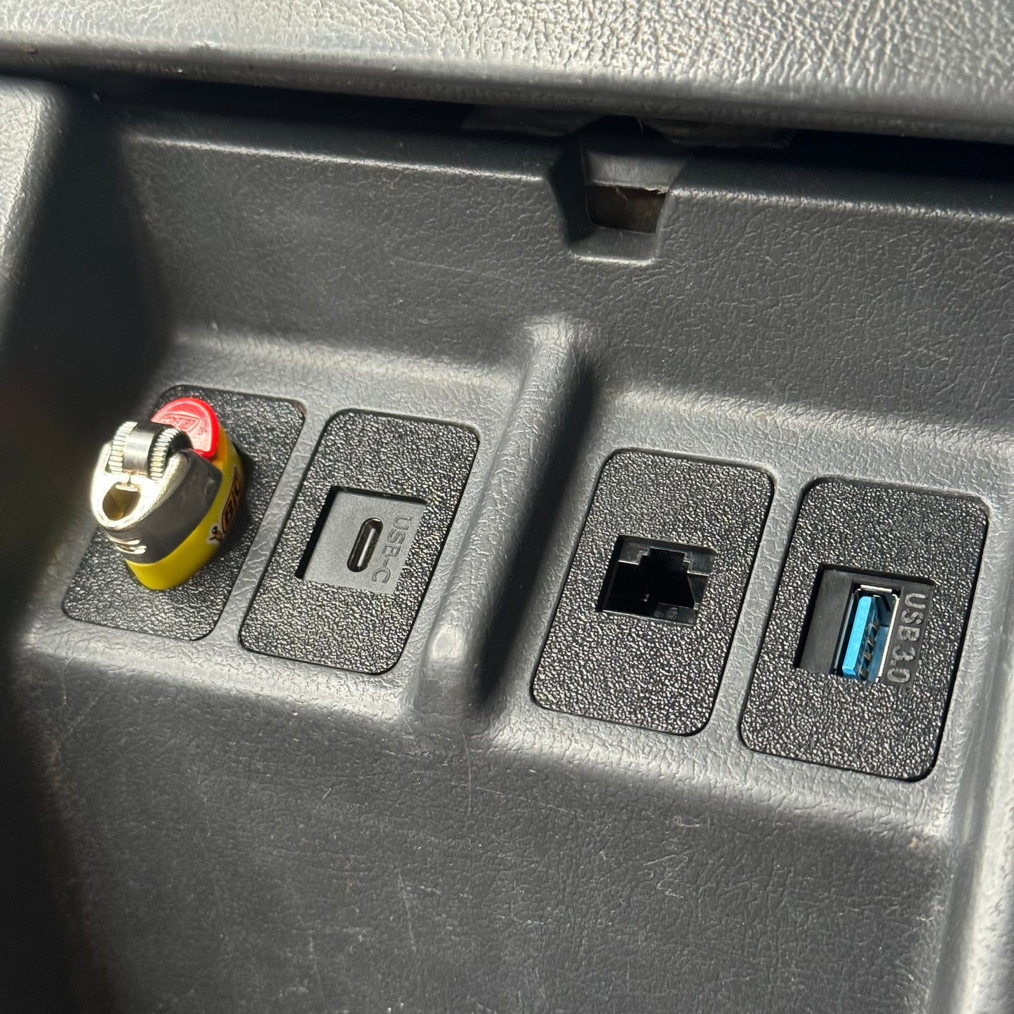 Nissan Patrol GQ Ford Maverick centre console close up with bic lighter holder installed