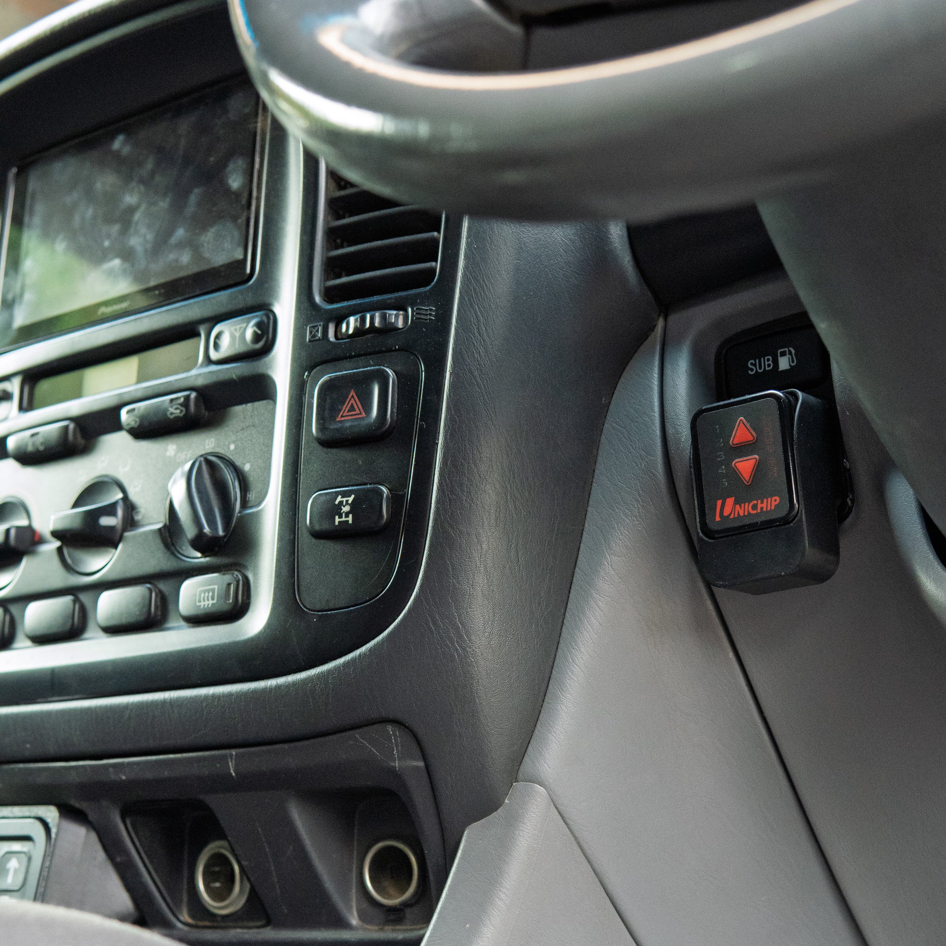 Landcruiser Unichip mount installed to 100 105 series Landcruiser in car close up
