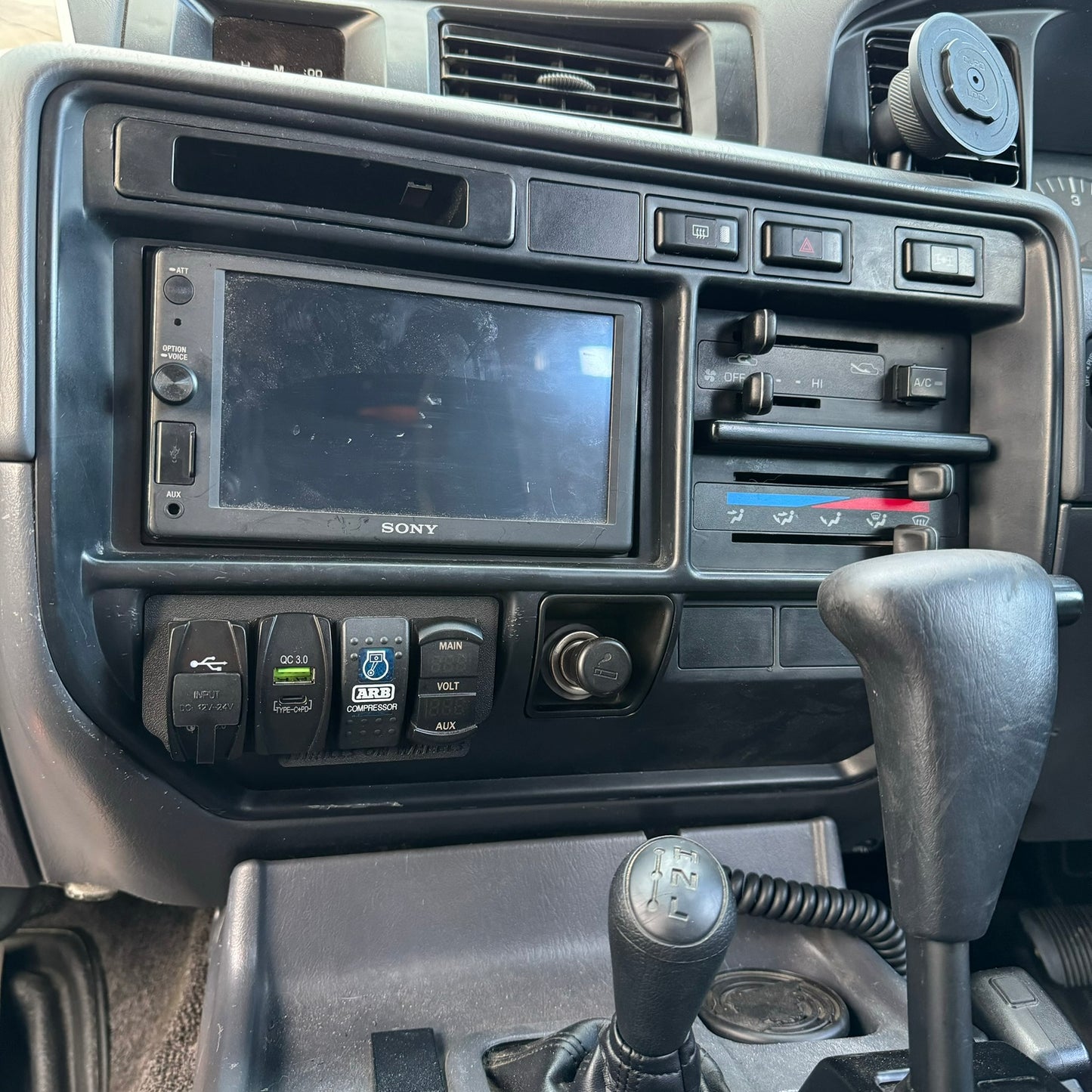 Toyota Landcruiser 80 Series late model ashtray switch plate with rocker switches installed in car