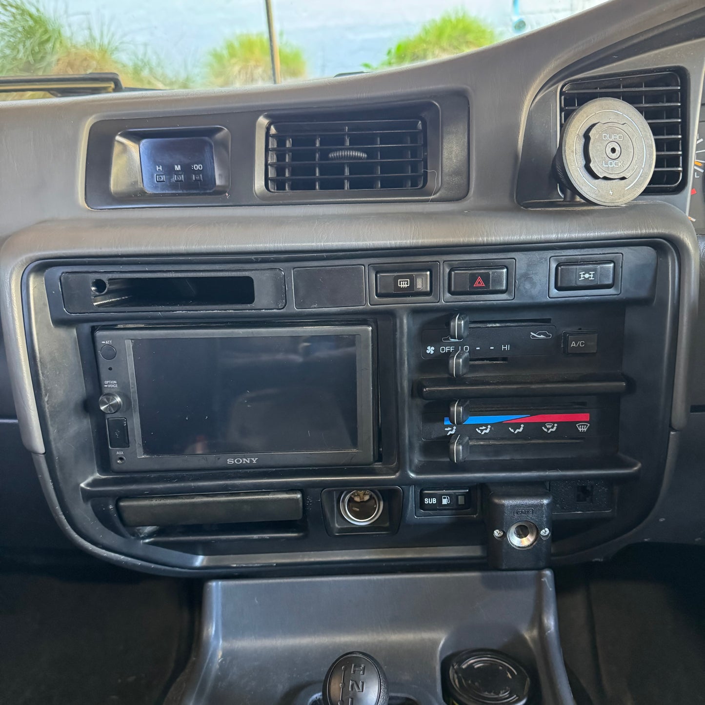 Toyota landcruiser 80 series club permit logbook storage holder installed in car to radio surround trim without book or pen