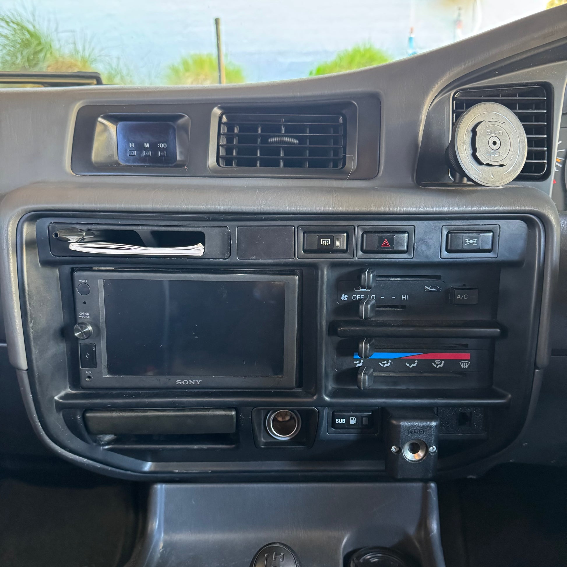 Toyota landcruiser 80 series club permit logbook storage holder installed in carto radio surround trim with pen and book